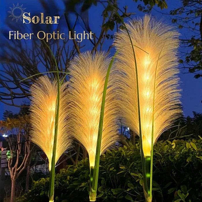 Set of 4 durable Outdoor Reed Garden Lights illuminating a garden landscape, enhancing ambiance.