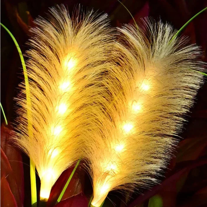 Multiple Outdoor Reed Garden Lights creating a beautiful, soft glow in a modern garden setting.