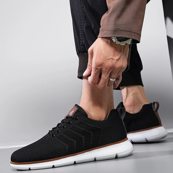 Athlete wearing Men's Airmesh Stride Running Sneakers on a track, showcasing flexibility & support.