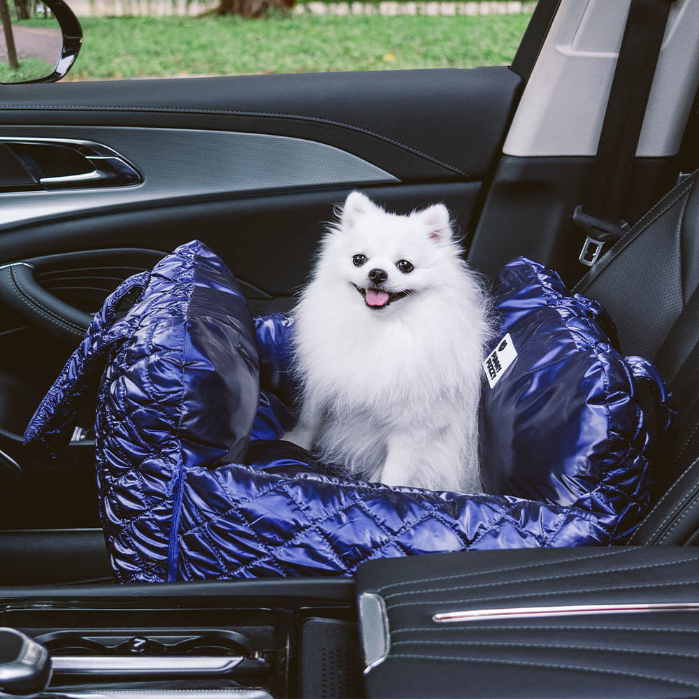 Dog enjoying a ride in a Cloud Luxury Quilted Dog Car Seat Booster Bed, cozy pet travel