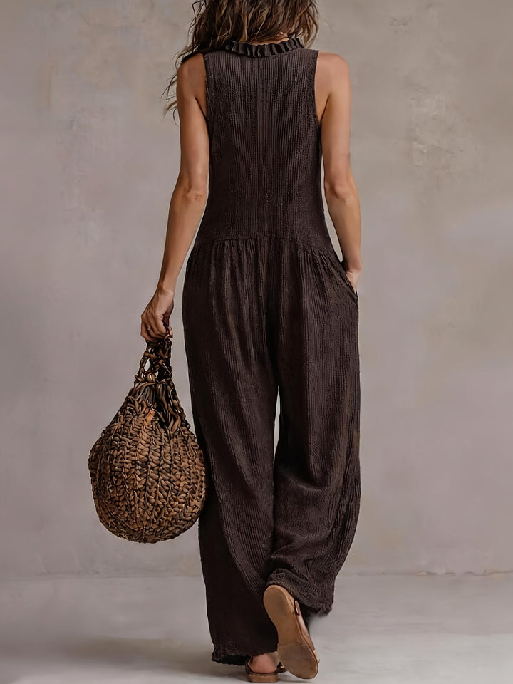 Effortless coffee brown wide leg jumpsuit, women's, with smocked waist & ruffle V-neck; ideal summer vacation wear.