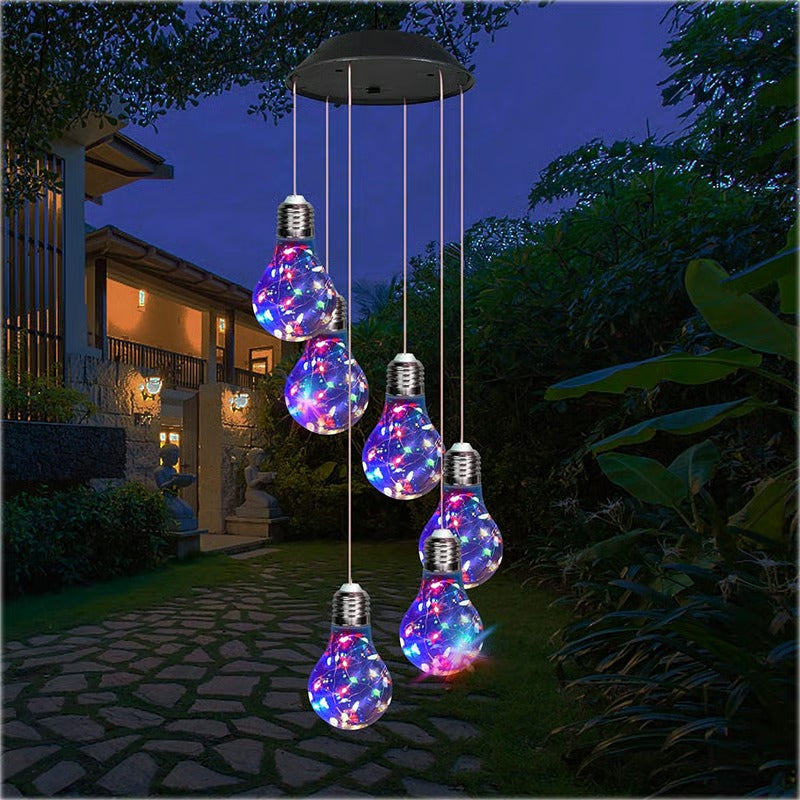 Colorful solar LED light bulb wind chime, outdoor decor for garden, glowing at dusk