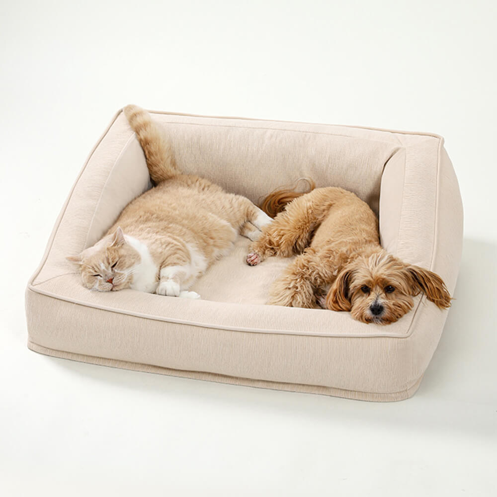 Soft grey pet sofa bed, orthopedic foam base, includes two comfy pillows for joint support.