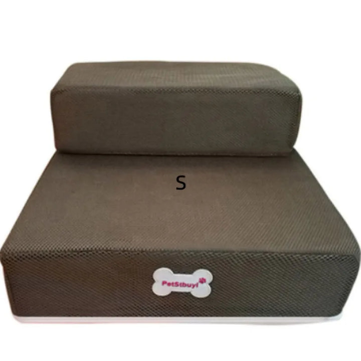 Pet stairs in use by a small dog, comfortably climbing to reach a bed, joint support