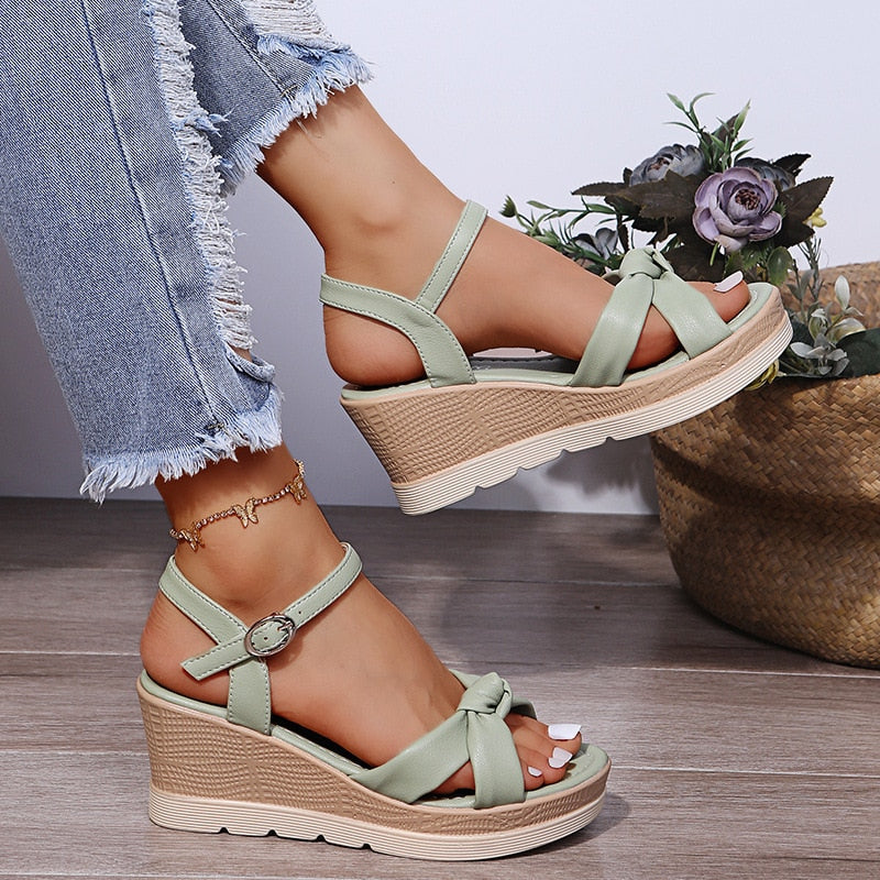 Elegant women's platform wedge sandals with ankle strap, chic summer footwear for comfort & style.