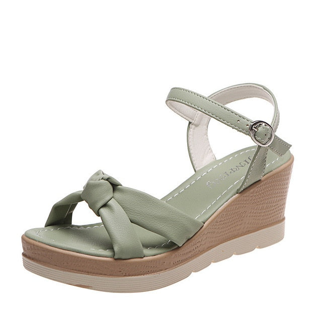 Fashionable women's platform wedge sandals with secure ankle strap, perfect open-toe summer footwear.