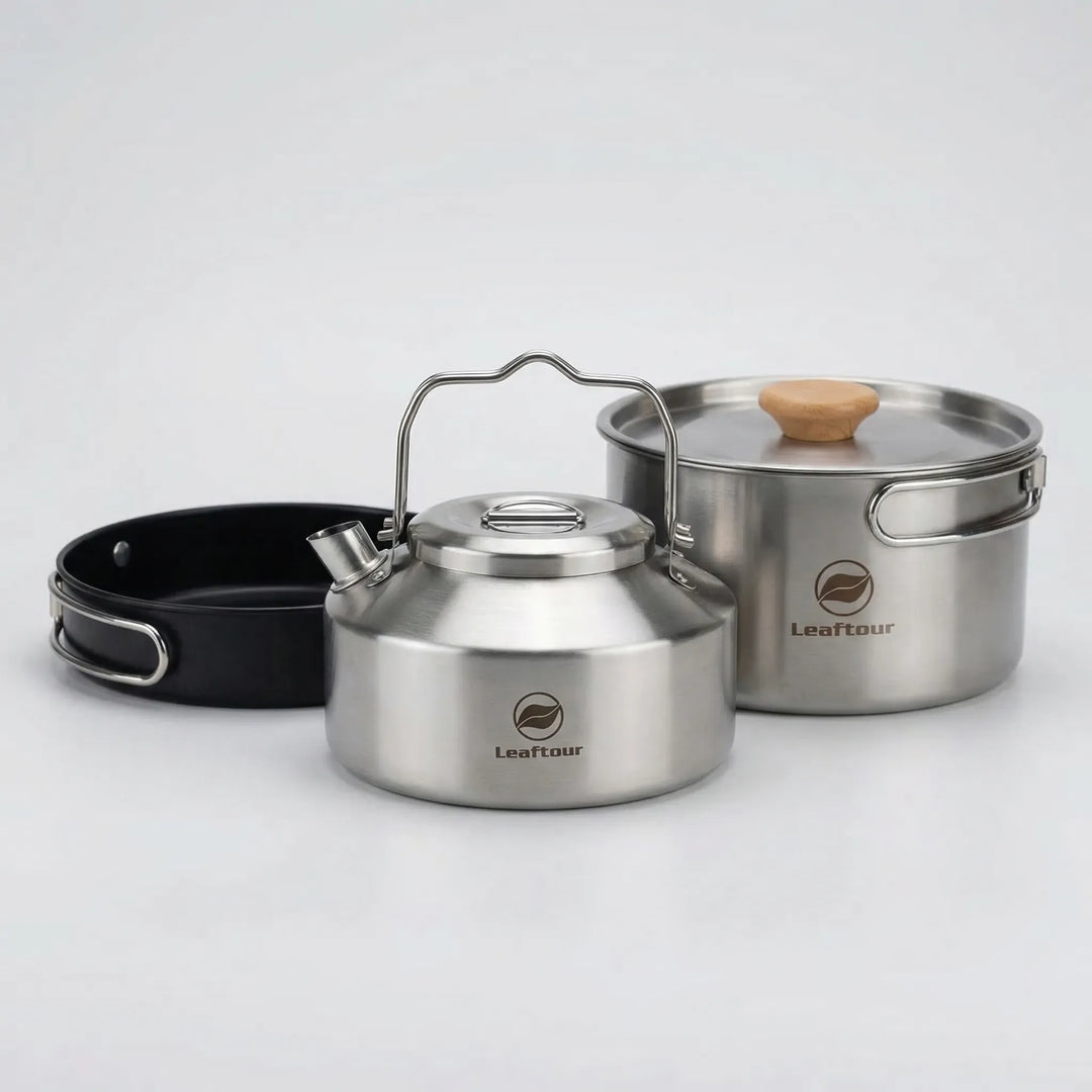Durable compact camping cookware set with pot, pan & kettle, ideal for outdoor kitchen & hiking adventures.