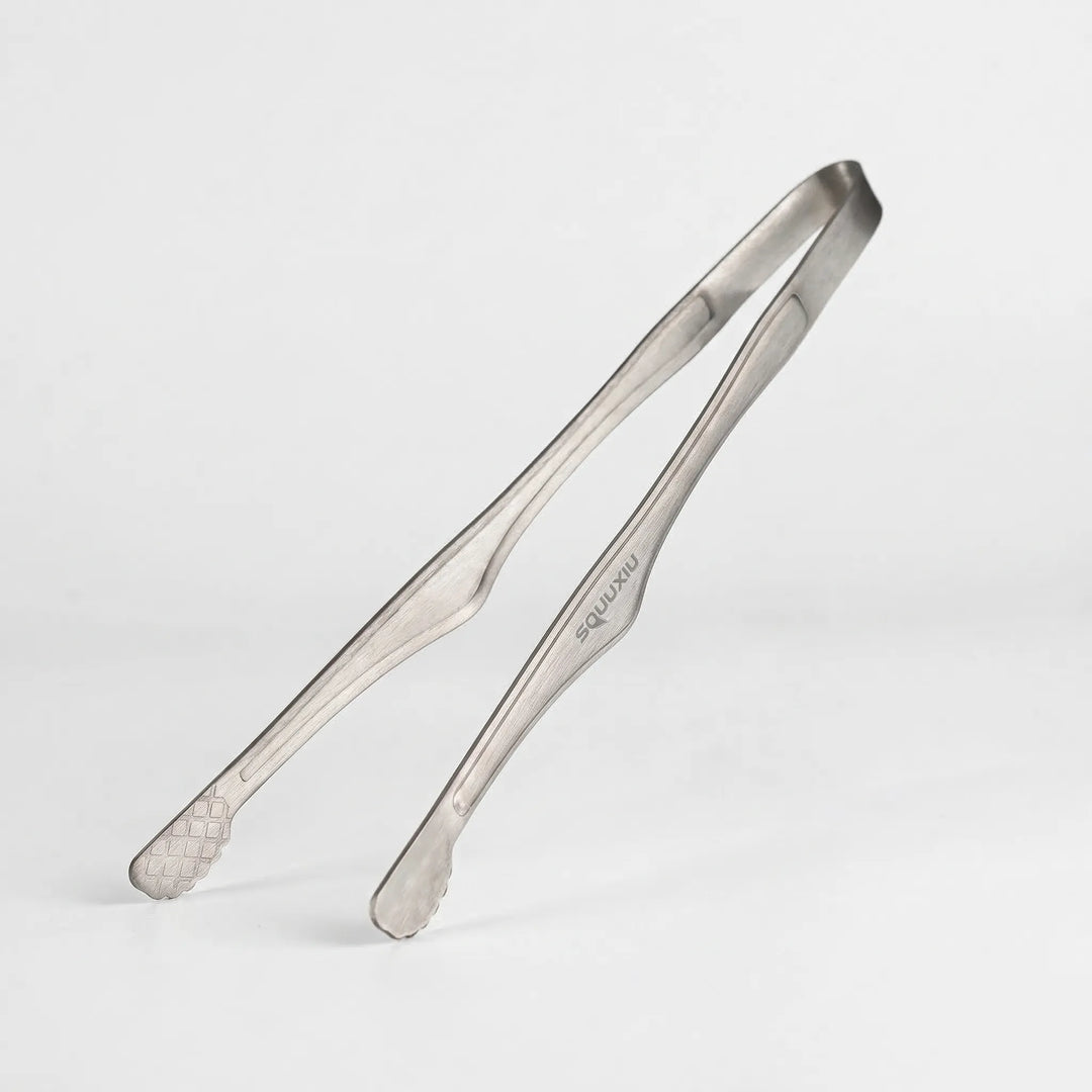 Essential outdoor cooking set: a non-stick camping grill plate & sturdy tongs for delicious meals.