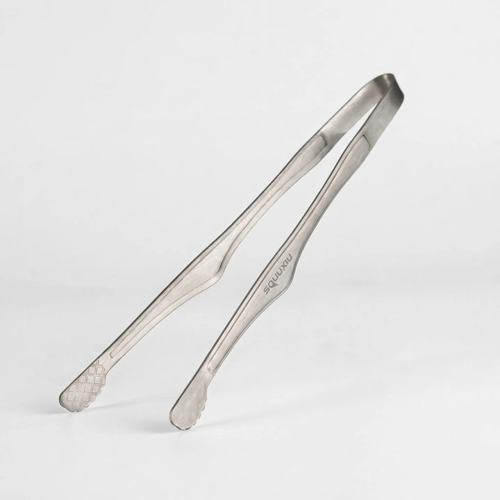 Essential outdoor cooking set: a non-stick camping grill plate & sturdy tongs for delicious meals.
