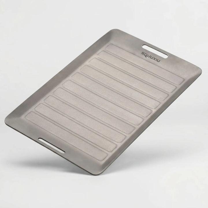 Versatile portable grill plate with tongs, designed for efficient and enjoyable outdoor grilling & camping.