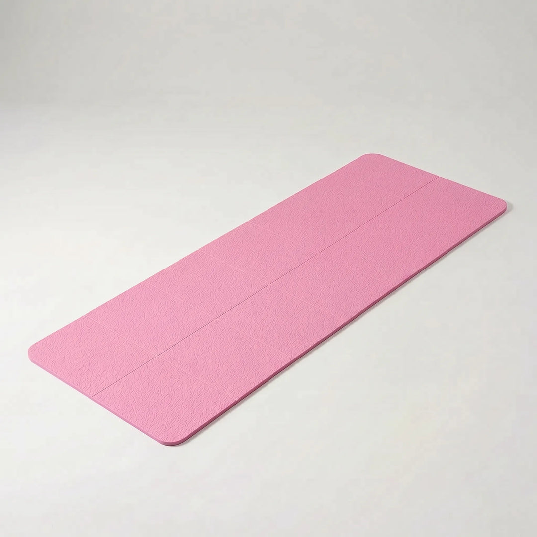 Unisex foldable grey exercise mat, ideal for yoga, pilates, and lightweight travel fitness.