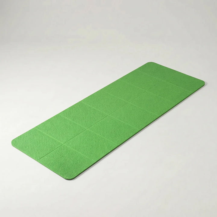 Folded TPE travel yoga mat, showing its ultra-compact size for easy packing in luggage or gym bags.
