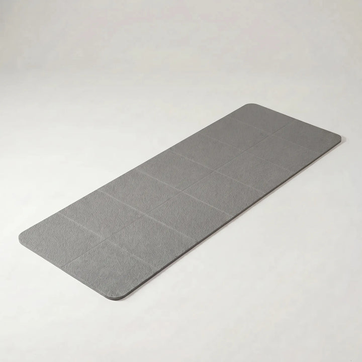 Durable & lightweight foldable yoga mat for travel, ensuring non-slip grip during outdoor or indoor practice.