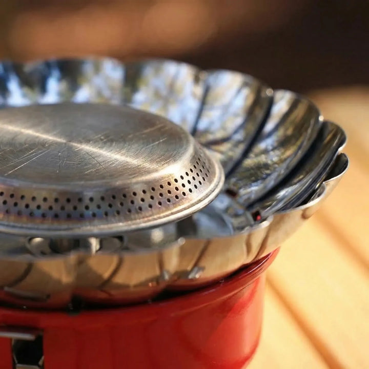 Windproof outdoor camping stove with a compact folding design, perfect for efficient cooking on trails or camp kitchen.