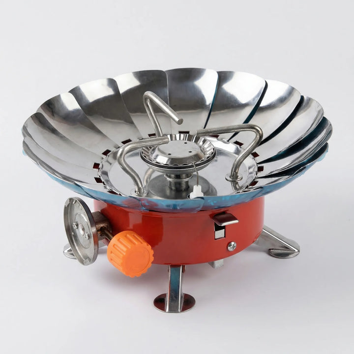Folding windproof camping stove for outdoor cooking, backpacking, and hiking. Compact & portable survival gear burner.