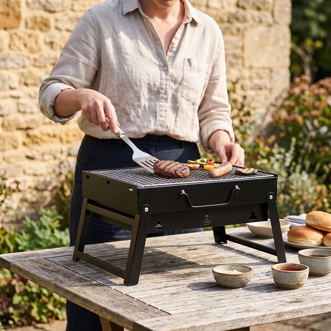 Compact portable charcoal folding grill, perfect for outdoor BBQ, camping, and picnics.