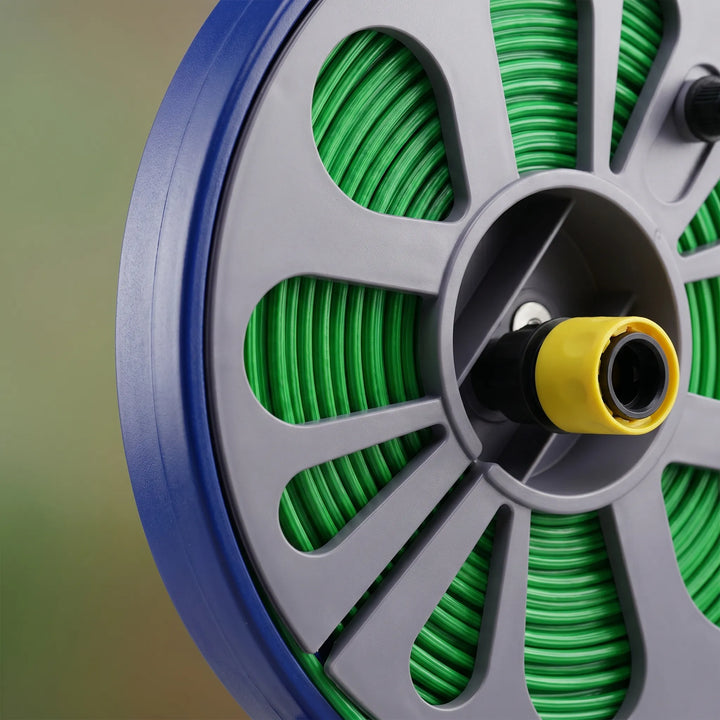Compact portable garden hose reel with flat hose for efficient watering system and convenient outdoor use.