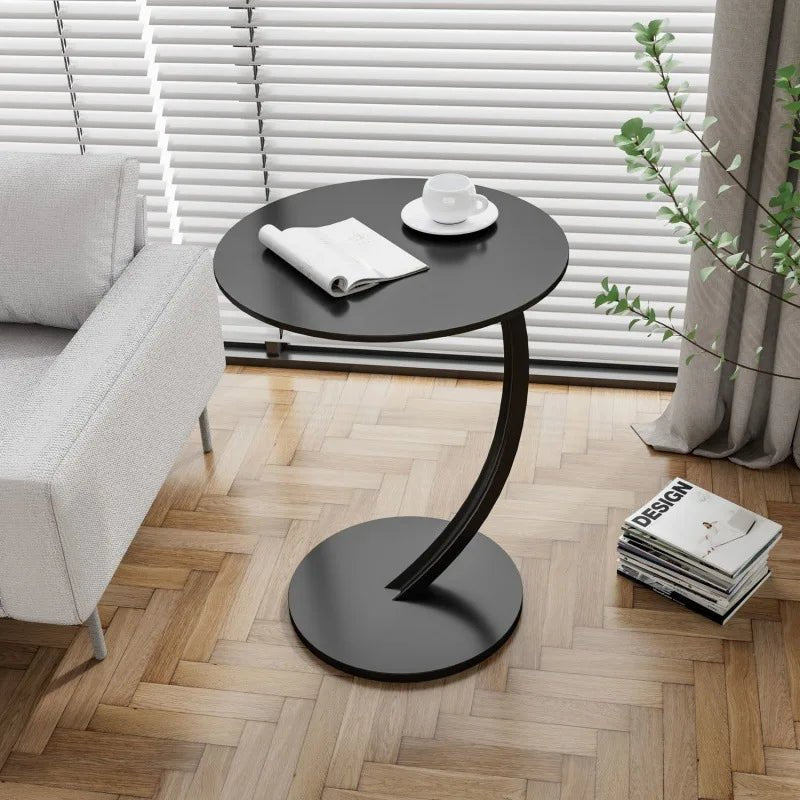 Stylish small round accent table, versatile for living room or bedroom.
