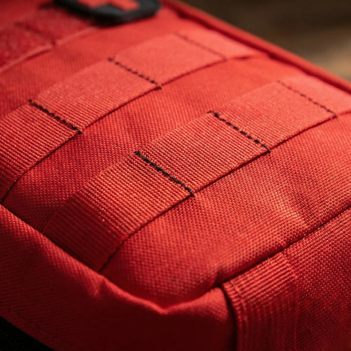Compact utility first-aid pouch, essential travel & hiking accessory. Holds emergency medical supplies for outdoor use.
