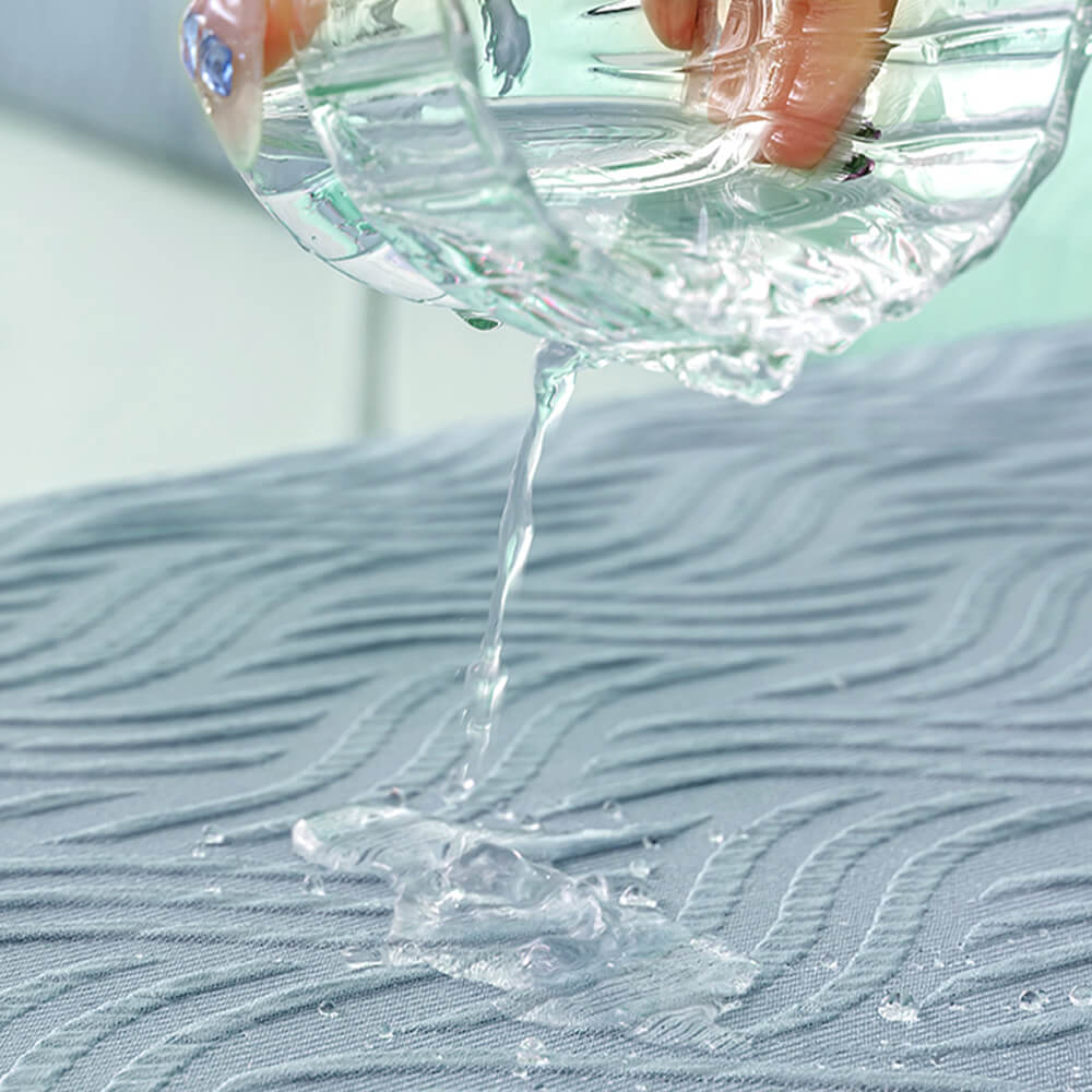 Close-up of the cooling fabric texture of the water-resistant stretch sofa cover, light gray