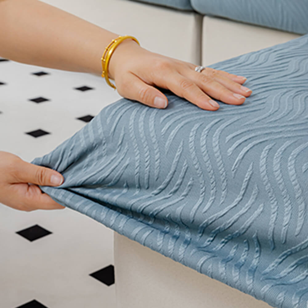 Water droplets beading up on the surface of the antifouling stretch sofa cover, showing resistance