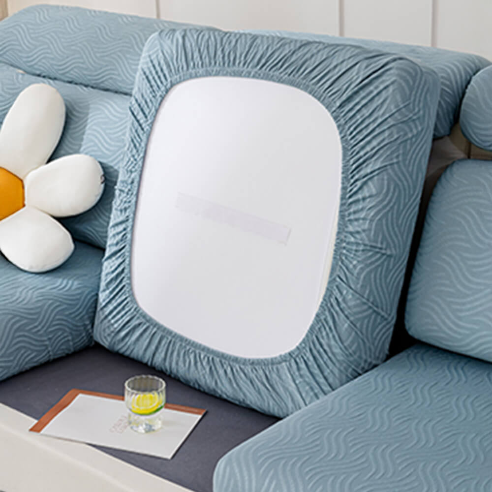 A vibrant blue cooling water-resistant stretch sofa cover installed on a contemporary armchair