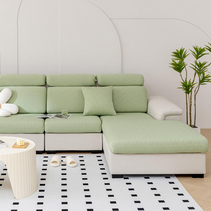 Detailed view of the stretchable material of the sofa cover conforming to unique furniture shapes