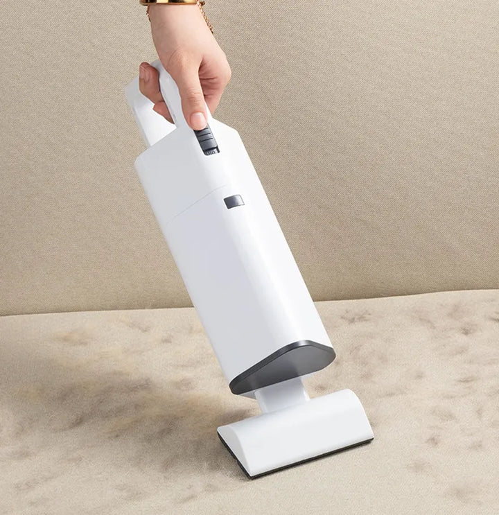 Handheld vacuum cleaner on a kitchen counter, versatile for home and car use.