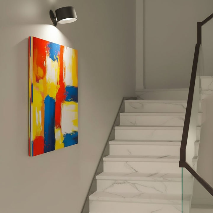 Modern pivoting LED wall light. Cordless, magnetic, & rechargeable for flexible home lighting.