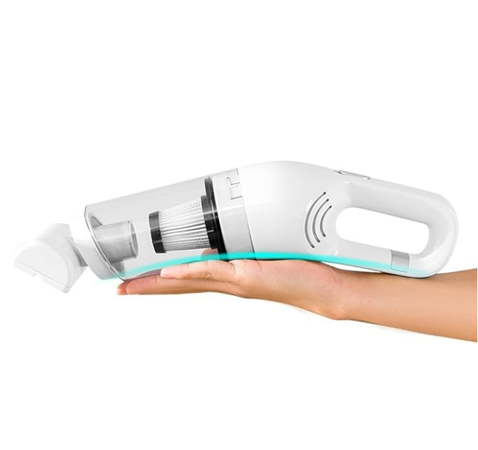 Cordless pet vacuum cleaning a sofa cushion, efficient pet hair remover for home