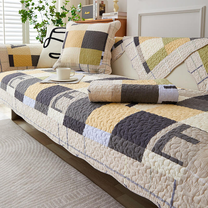 Machine washable cotton plaid couch cover draped over a sofa, offering pet protection and decor.