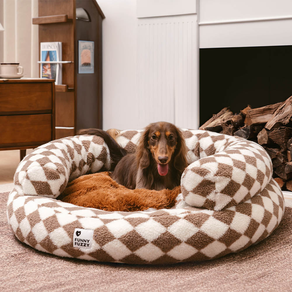 Beige argyle washable donut dog bed, a comfortable and stylish pet accessory.