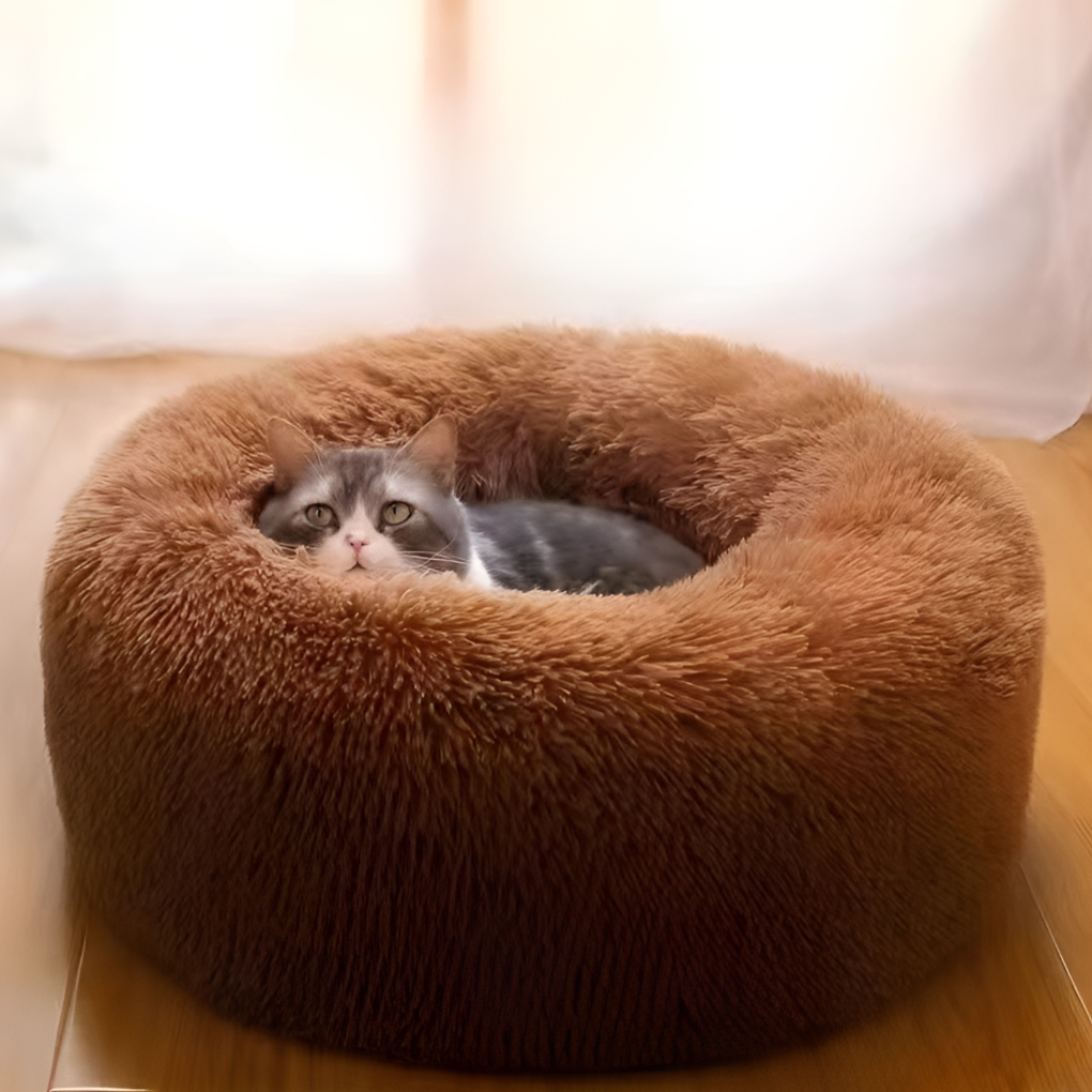 Soft round calming pet bed for anxiety relief in dogs and cats, washable faux fur finish