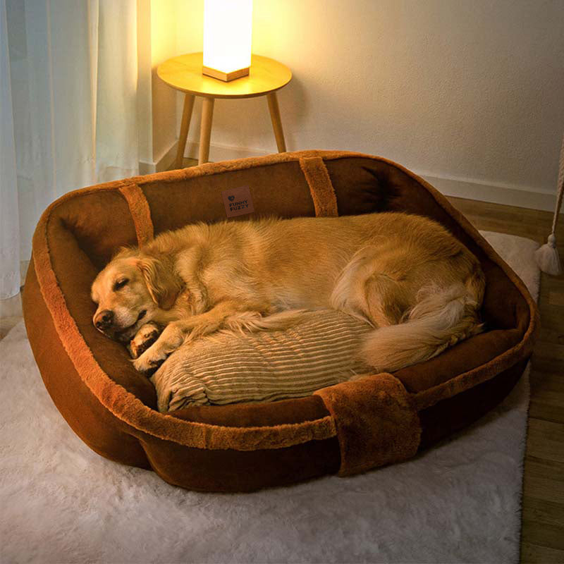 Cozy calming sofa dog bed with plush grey fabric and raised side, perfect for anxiety relief.
