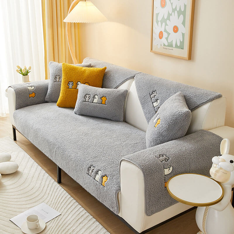Pet-proof sherpa fleece couch cover with fun cat paw pattern and anti-slip feature
