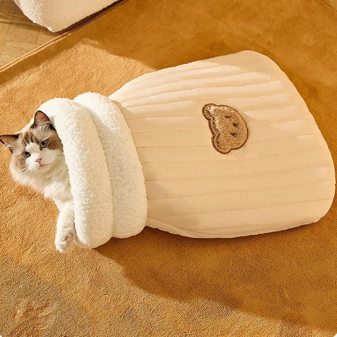 Folded plush cat sleeping bag ready for easy storage or travel, a convenient pet bed cavern