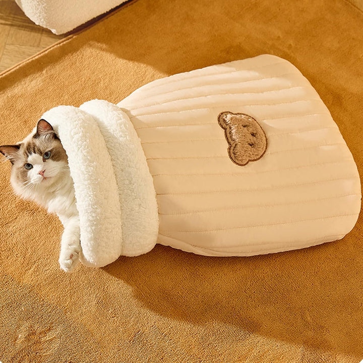 Folded plush cat sleeping bag ready for easy storage or travel, a convenient pet bed cavern