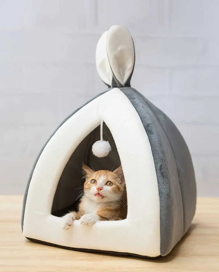 Cozy gray cat cave bed with a dangling play ball, plush and comfortable design for felines