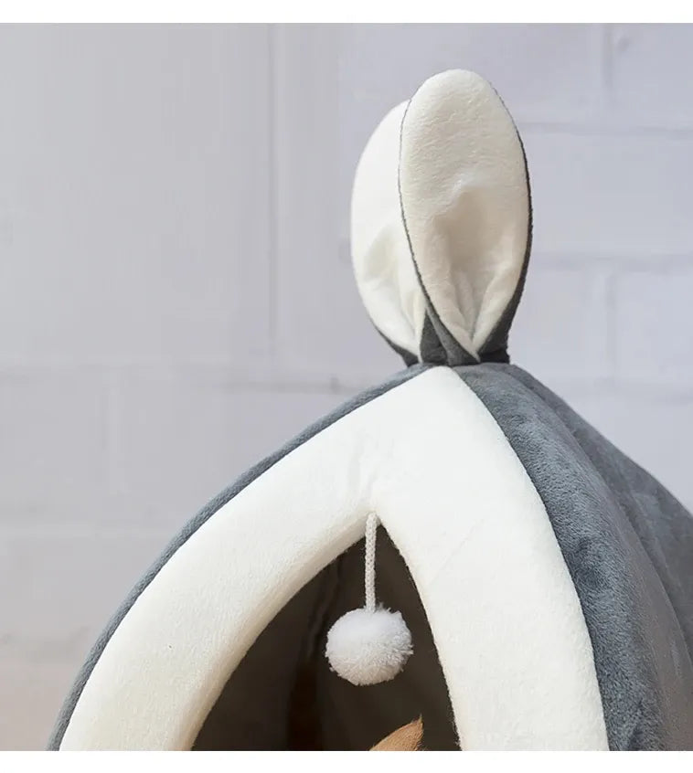 Plush gray cat cave bed, providing a secure and cozy spot for cats, with an attached toy