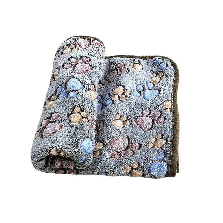 Folded coral fleece pet blanket, highlighting its compact and soft design for dogs and cats.