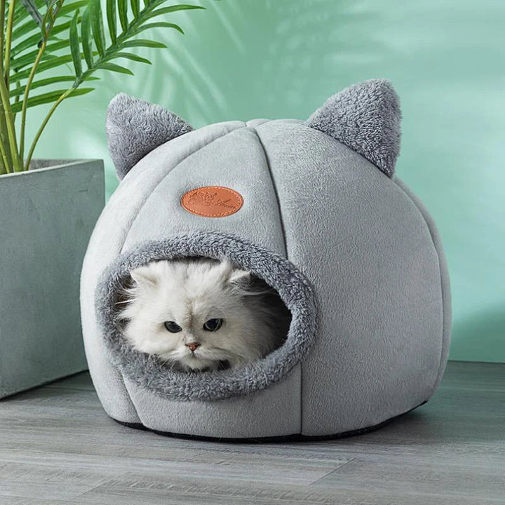 Pet bed cave providing cozy anxiety relief, featuring a tent design for cats and small dogs.