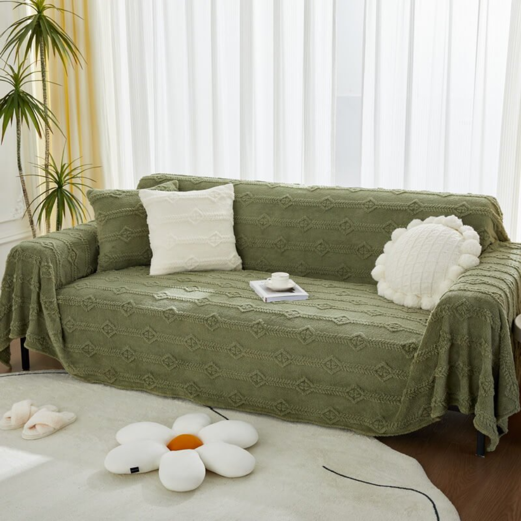 Boho style faux fur throw blanket, acting as a sofa cover, protecting furniture from pets and spills.