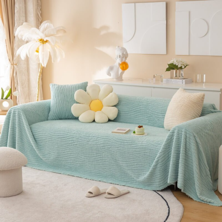Durable, pet-friendly faux fur throw blanket as a sofa cover, offering both comfort and furniture safeguarding.