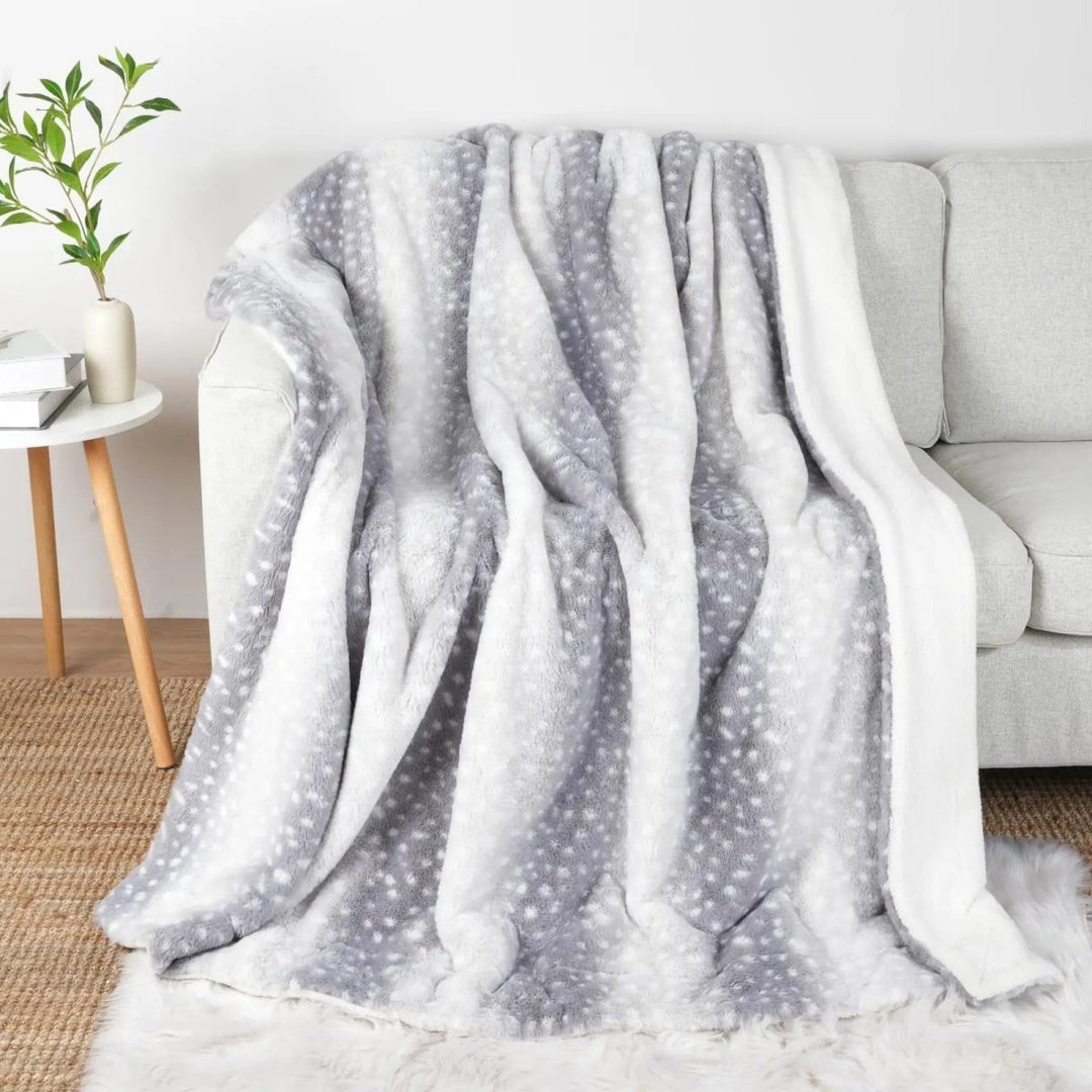 Stylish faux fur cozy blanket, a plush reversible throw adding warmth & animal print home decor.