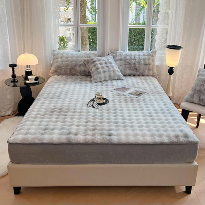 Warm and inviting faux rabbit fur mattress cover and pillowcases, adding luxury to bed.