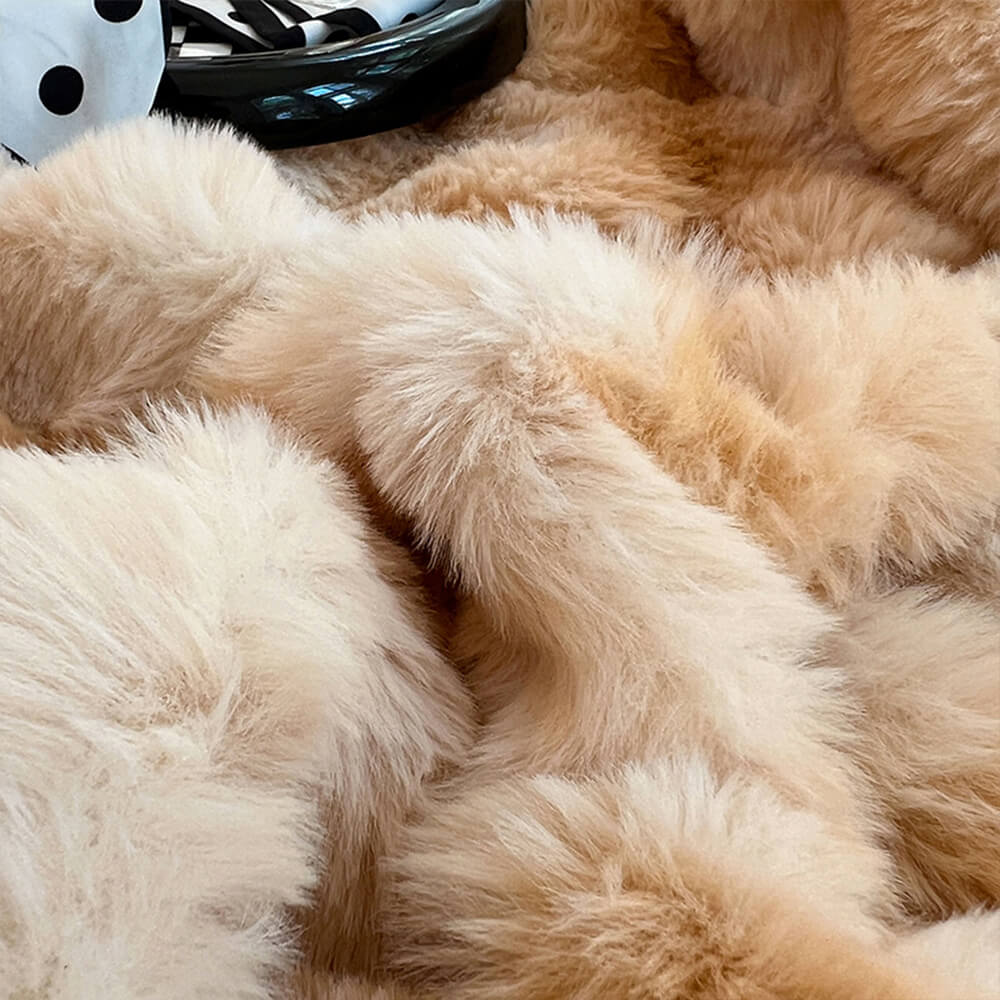 Soft faux rabbit fur fitted sheet on a queen-sized bed with matching pillowcases, close-up texture.