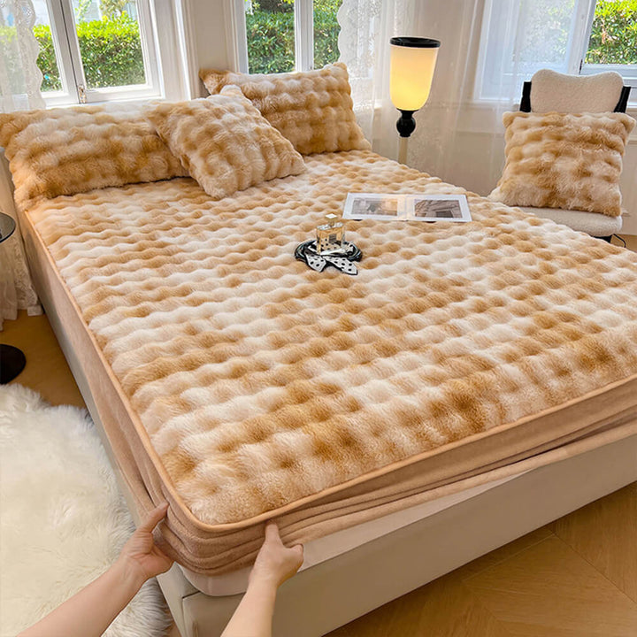 Elegant faux fur bedding set: fitted sheet and pillowcases in a neutral tone, home decor.