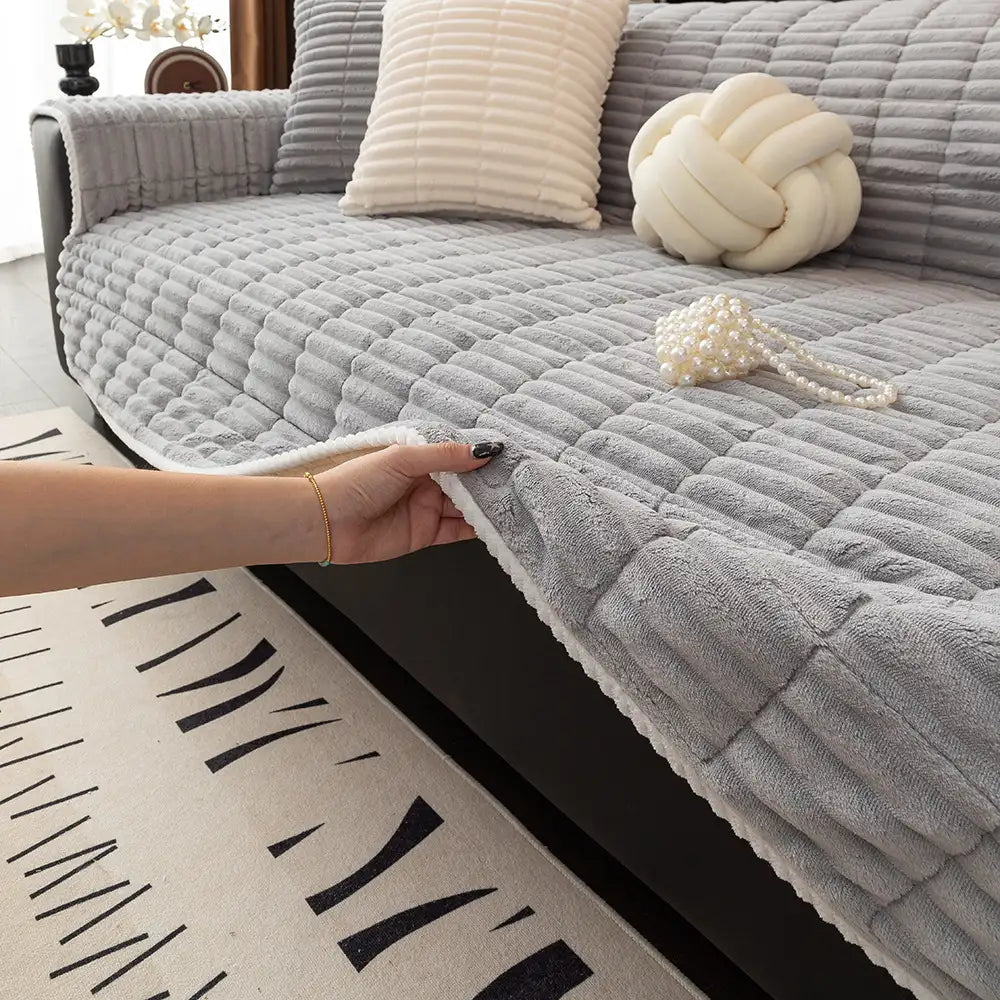Flannel sofa cover with non-slip dots on the back, shown on a cream-colored couch.