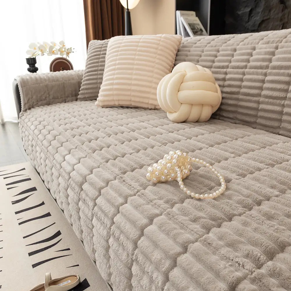 Soft flannel couch protector with anti-slip backing, ideal for homes with dogs or cats.