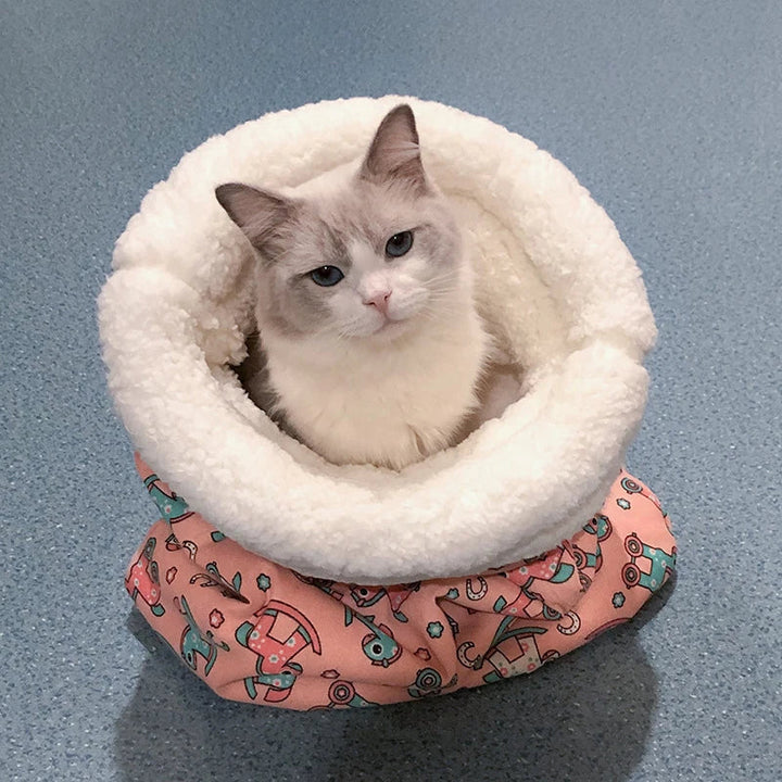 Multifunctional pet accessory: a cat sleeping bag and play tunnel, promoting rest and activity.